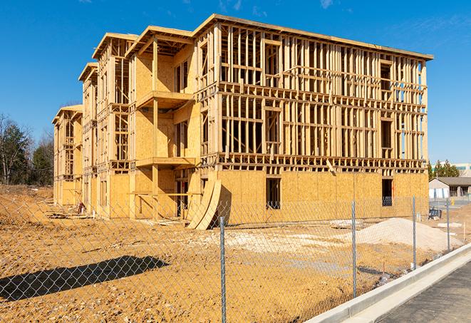 a job site enclosed by temporary chain link fences, ensuring safety for workers and pedestrians in Flower Mound, TX